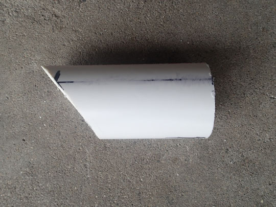 Cut a piece of PVC pipe at an angle to piece through the dirt.