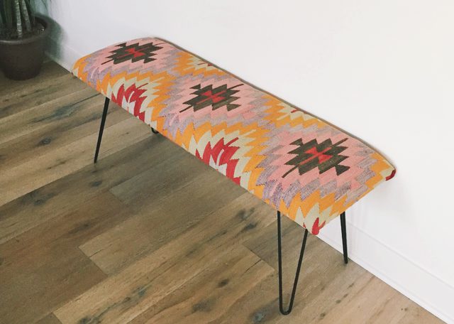 Use an area rug to create a colorful mid-century inspired bench. Image via eHow.
